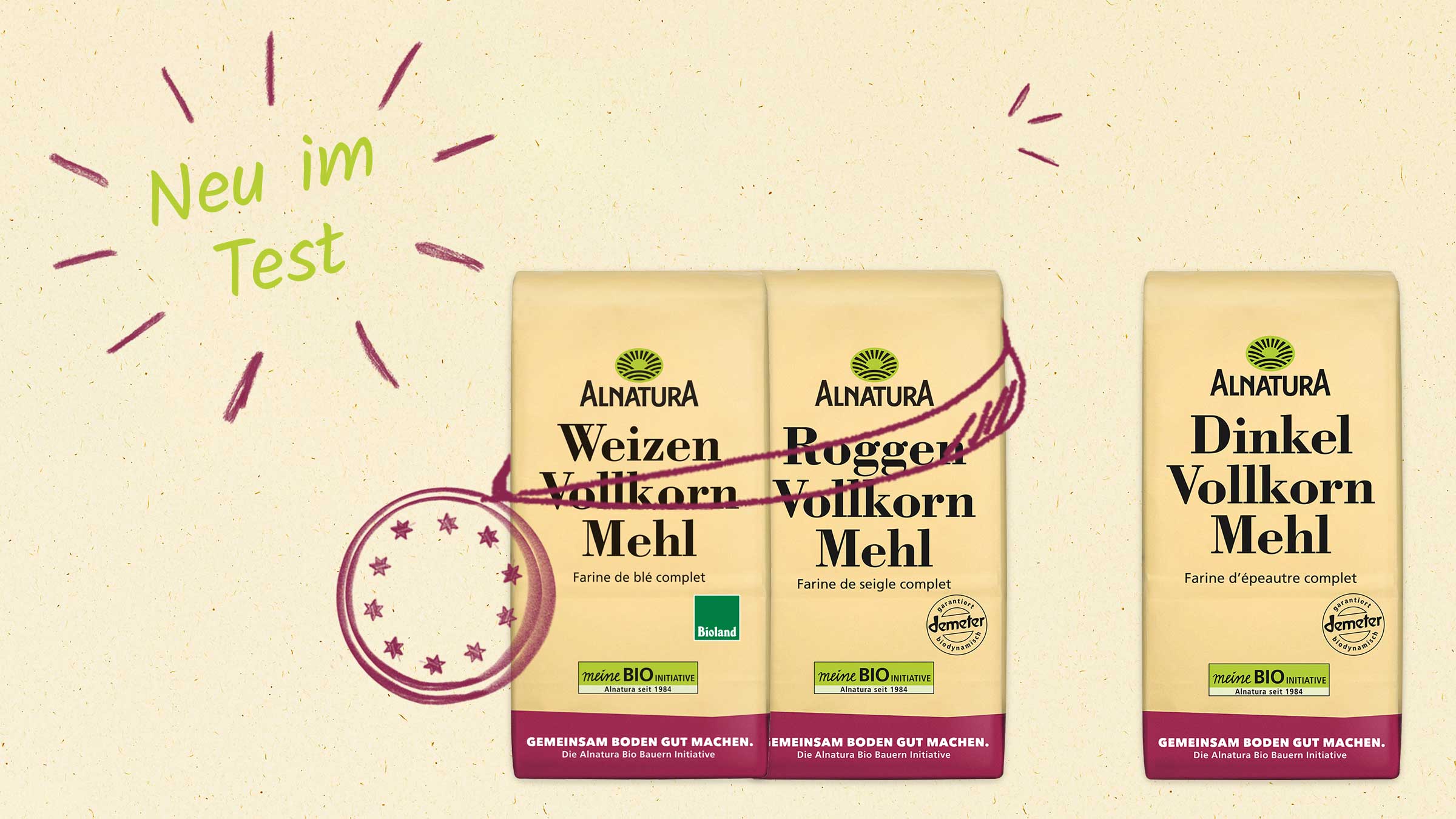 Drei Packungen Alnatura Vollkornmehl (Weizen, Roggen, Dinkel) werden gezeigt, mit der Aufschrift "Neu im Test" und Dekorationen.