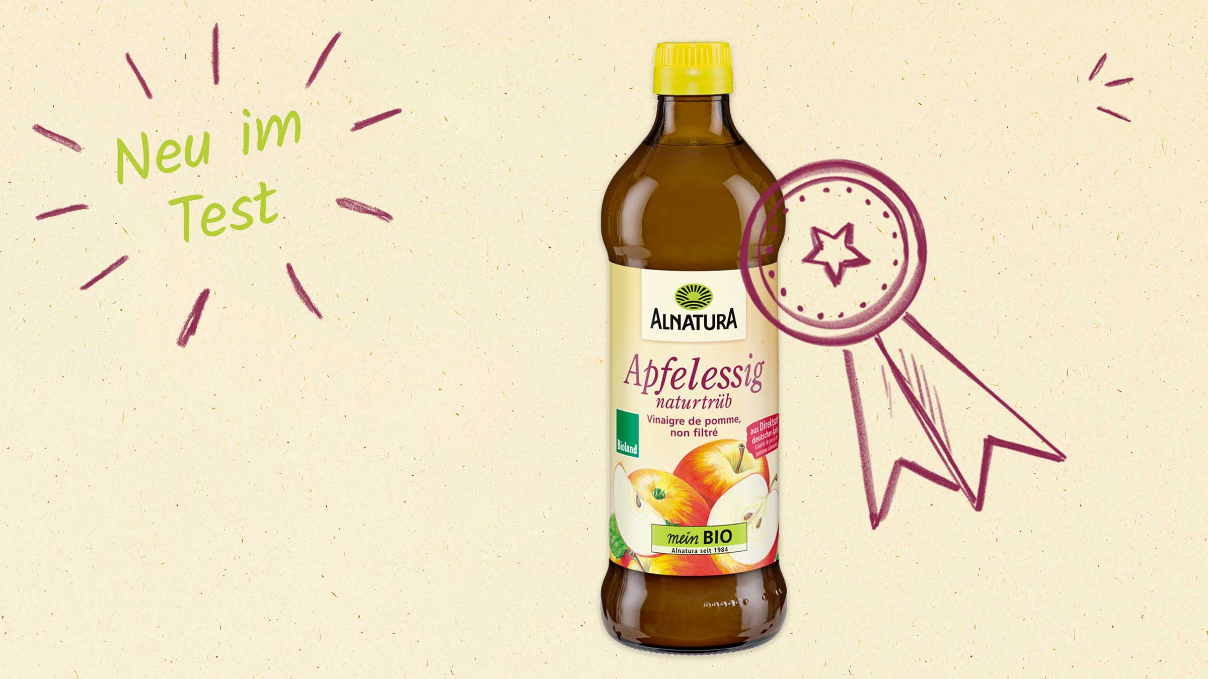 Eine Flasche naturtrüber Bio-Apfelessig von Alnatura mit einem stilisierten Sternen-Award und dem Aufdruck "Neu im Test".