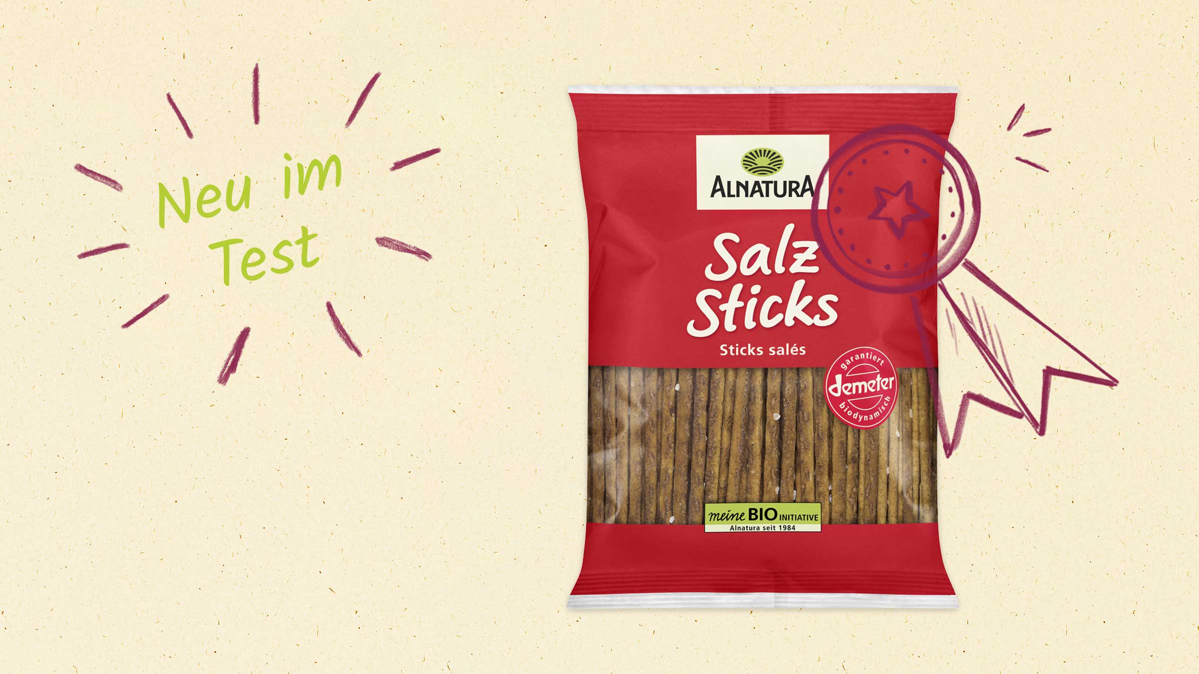 Ein roter Beutel Alnatura Salzstangen mit der Aufschrift "Neu im Test" und einem gezeichneten Qualitätssiegel.