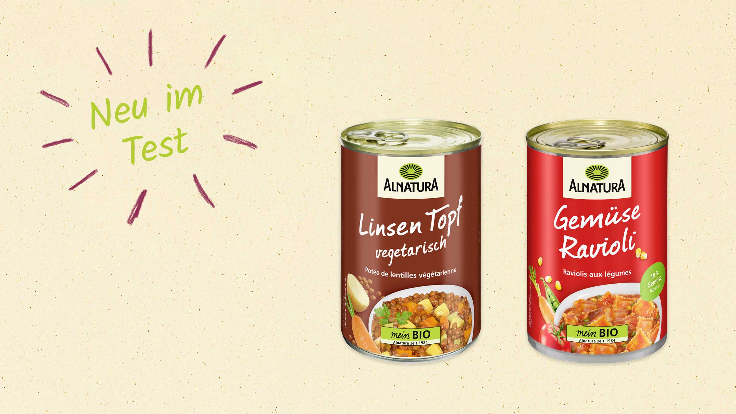 Zwei Dosen Alnatura-Produkte, ein Linsentopf und Gemüse-Ravioli, werden nebeneinander gezeigt. Links oben steht "Neu im Test".