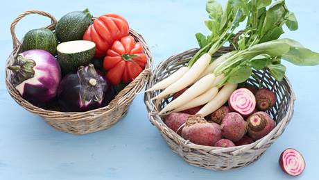 Prallgefüllte Gemüsekörbe mit Ochsenherztomaten, Zucchini, Radieschen, Eiszapfen, Rote Bete und Aubergine