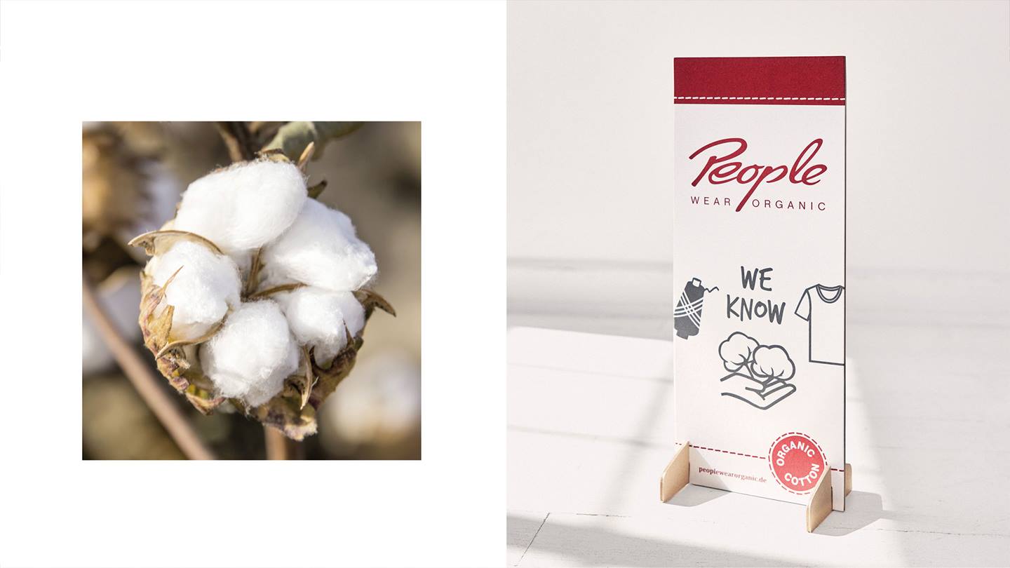 Das Bild ist zwei geteilt. Es zeigt auf der linken Seite eine Baumwoll-Pflanze und auf der rechten Seite einen Aufsteller mit dem Text "we know" organic cotton peoplewearorganic.de