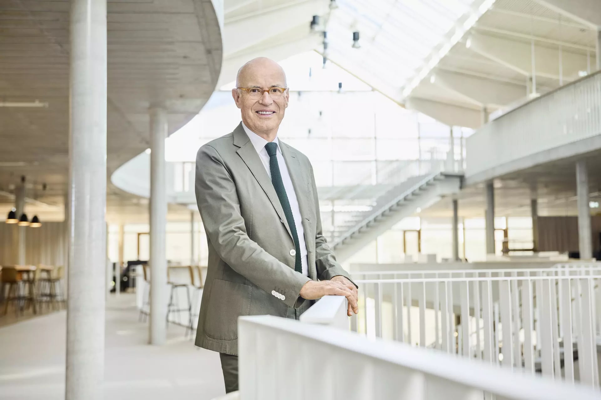 Herr Götz Rehn am Geländer im Campus von Alnatura. Gründer von Alnatura.